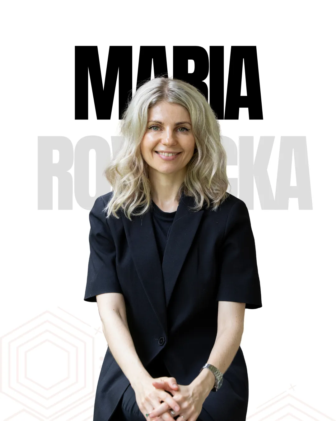 Portrait of a smiling blonde woman in a black blazer, seated against a white background with large MARIA text behind her.